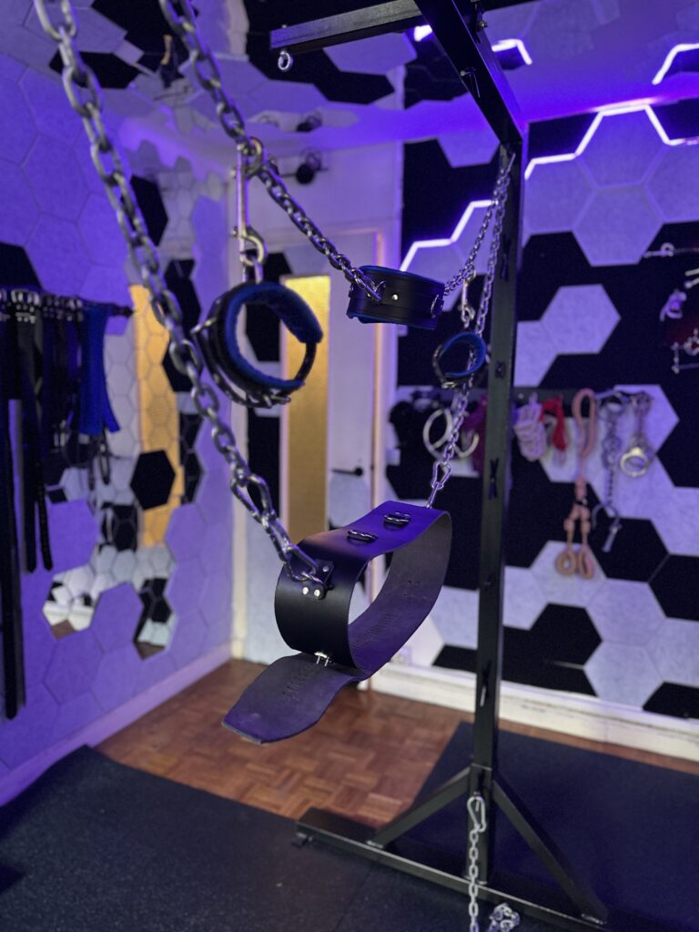 Chains and leather bondage set in the suspension bondage rig